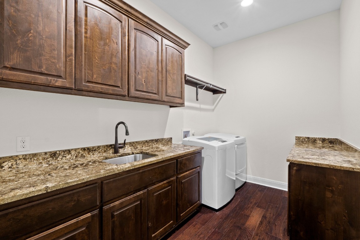 200 Tate Lane Round Rock, TX 78665 - Photo 29 of 40 a kitchen with stainless steel appliances granite countertop a sink stove and cabinets