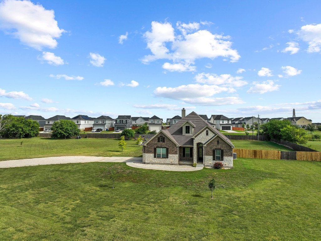 200 Tate Lane Round Rock, TX 78665 - Photo 3 of 40 a view of a house with a big yard and large trees