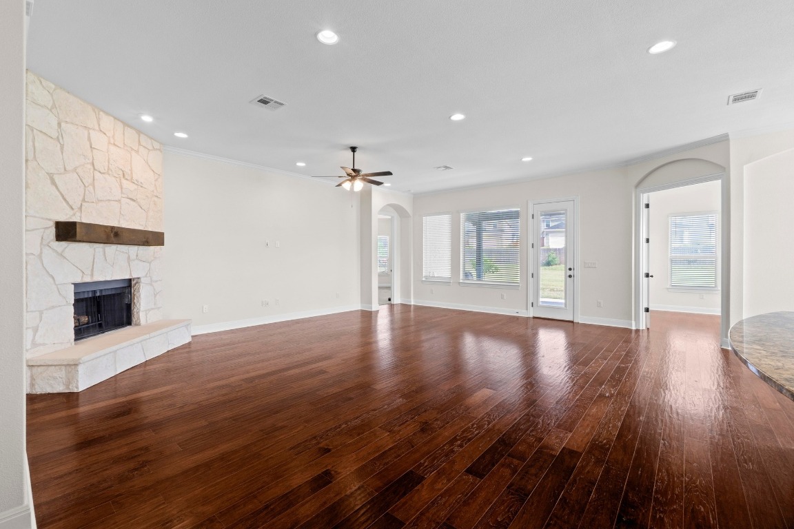 200 Tate Lane Round Rock, TX 78665 - Photo 5 of 40 a view of a big room with wooden floor and a kitchen