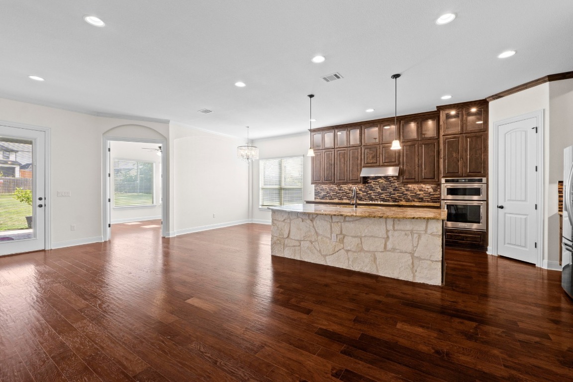 200 Tate Lane Round Rock, TX 78665 - Photo 8 of 40 a kitchen with a refrigerator and white cabinets