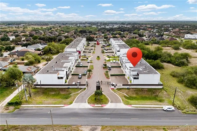 an aerial view of residential houses with outdoor space
