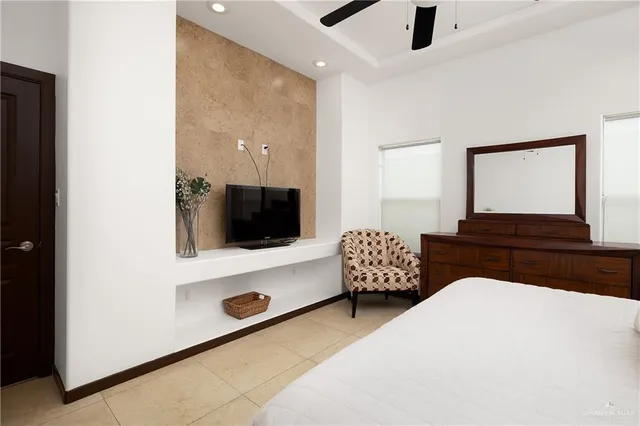 a bedroom with a bed and a flat screen tv