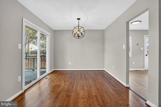 a view of an empty room and wooden floor