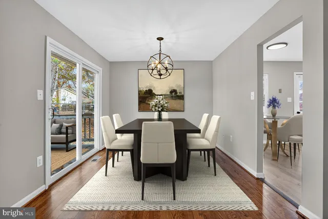 a view of a dining room with furniture wooden floor and a chandelier