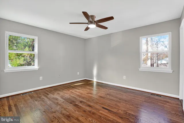 wooden floor in an empty room with a window