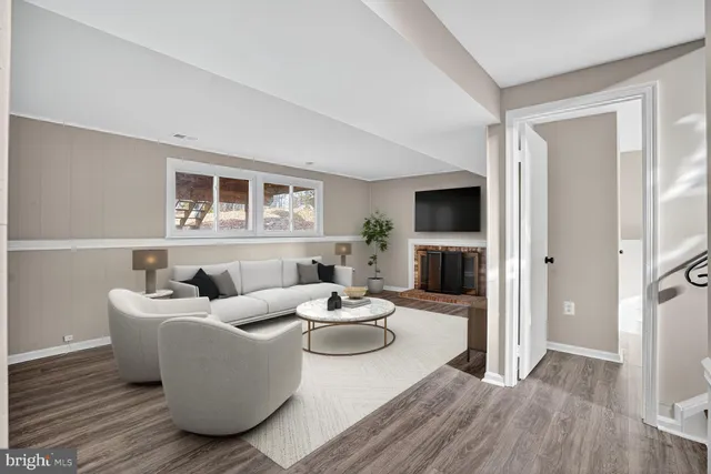 a living room with furniture a fireplace and a flat screen tv