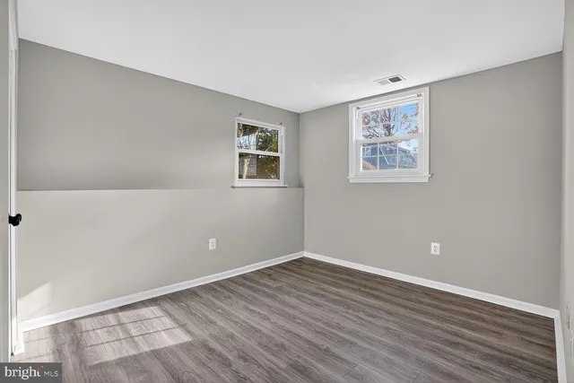 a bathroom with a granite countertop toilet and sink