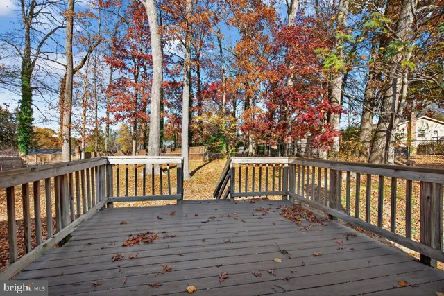 a balcony with wooden floor and trees