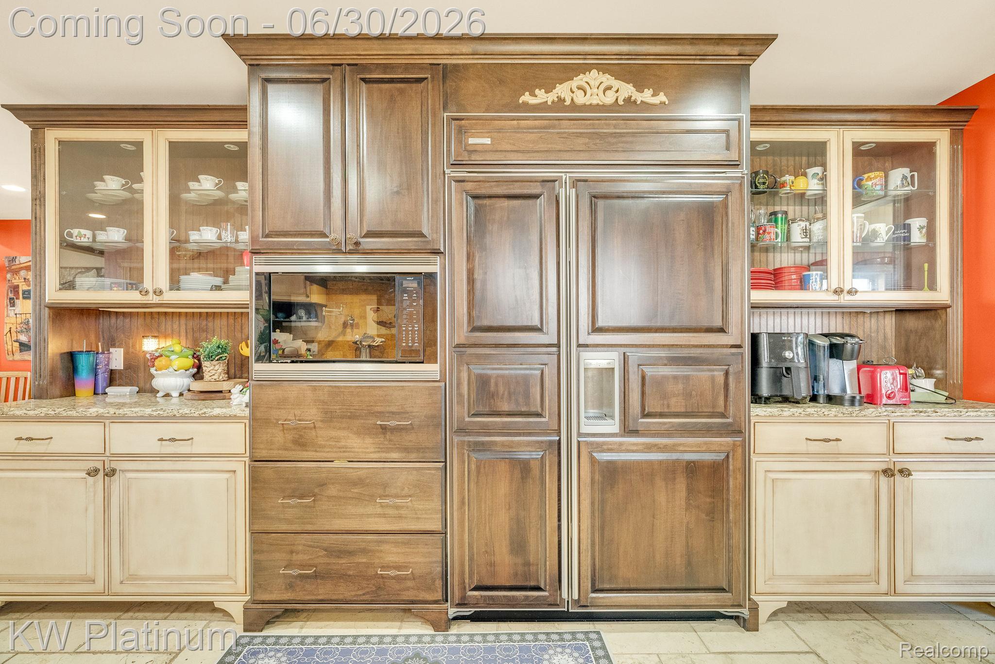 2235 South Lake Shore Road Harbor Beach, MI 48441 - Photo 13 of 99 Custom built-in cabinetry featuring a wood-panel refrigerator, integrated microwave, and glass-front upper cabinets