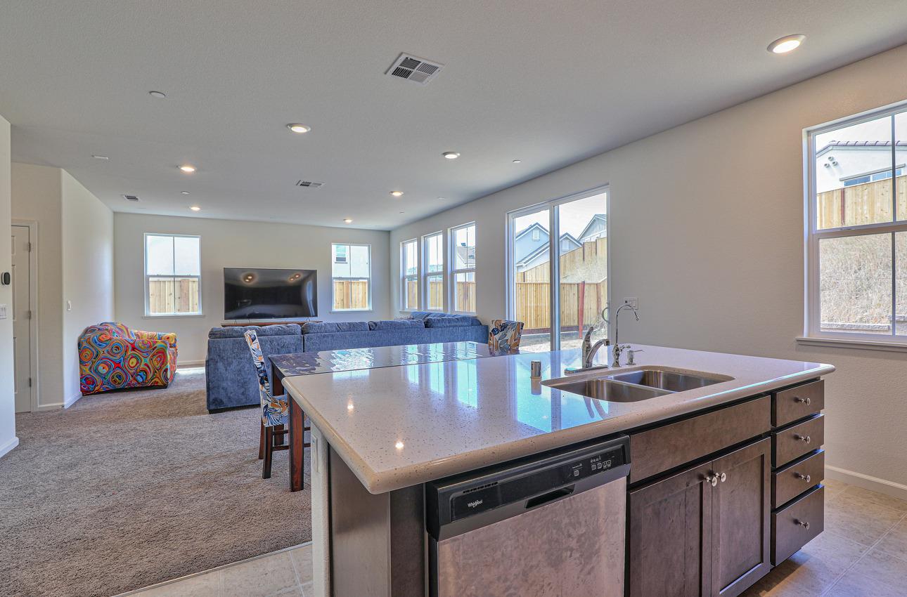 1400 Winzer Place Gilroy, CA 95020 - Photo 17 of 33 a kitchen with stainless steel appliances granite countertop a sink dishwasher and a flat screen tv