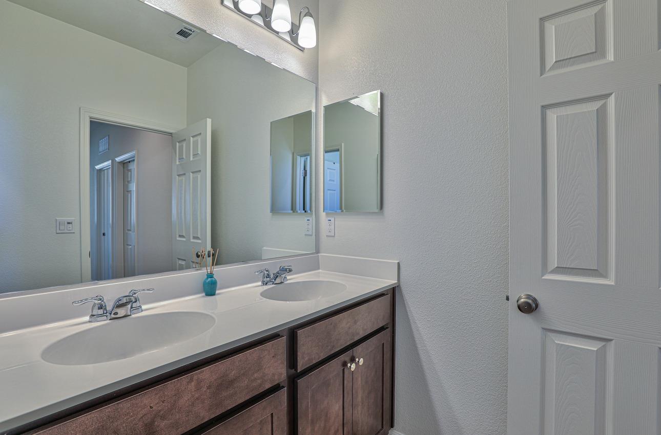 1400 Winzer Place Gilroy, CA 95020 - Photo 31 of 33 a bathroom with a double vanity sink and a mirror