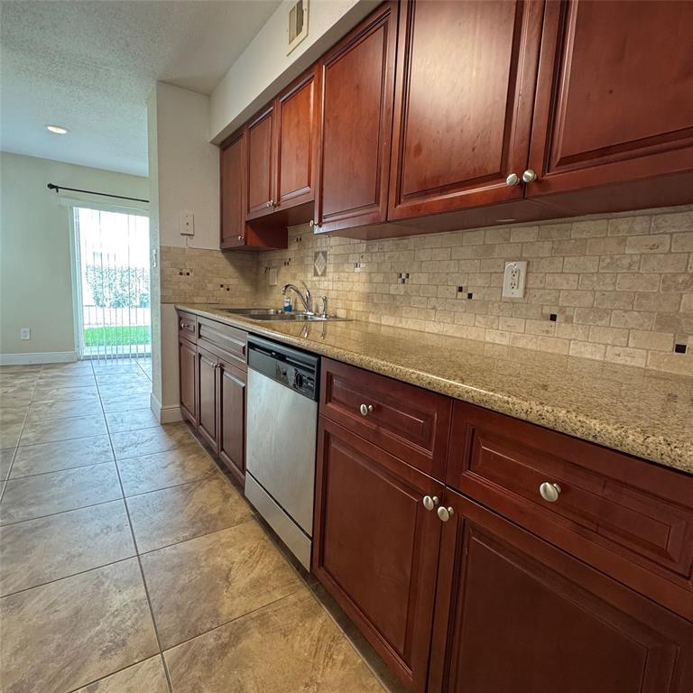 805 Riverside Drive, Unit 1112 Coral Springs, FL 33071 - Photo 1 of 26 a kitchen with stainless steel appliances granite countertop a sink and cabinets