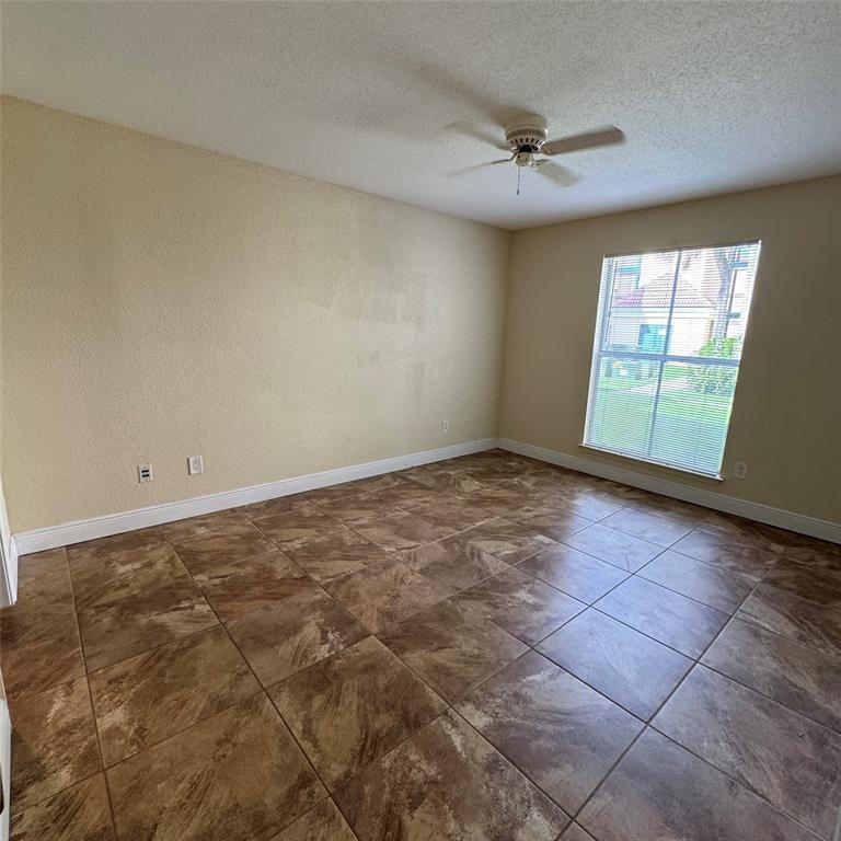 805 Riverside Drive, Unit 1112 Coral Springs, FL 33071 - Photo 14 of 26 an empty room with a ceiling fan and window