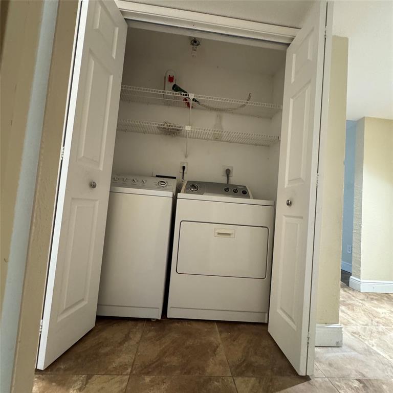 805 Riverside Drive, Unit 1112 Coral Springs, FL 33071 - Photo 18 of 26 a utility room with dryer and washer