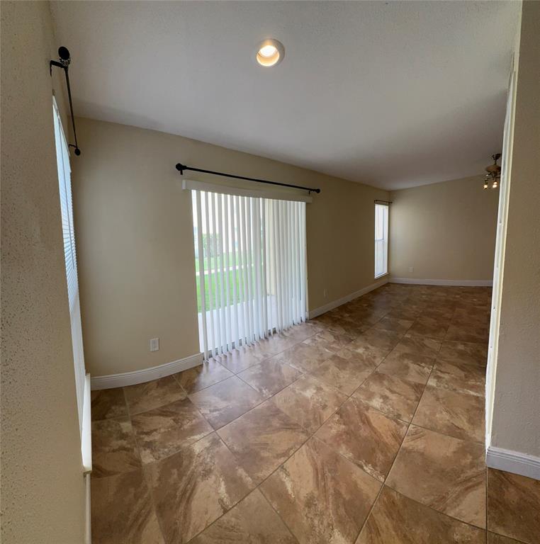 805 Riverside Drive, Unit 1112 Coral Springs, FL 33071 - Photo 7 of 26 an empty room with windows
