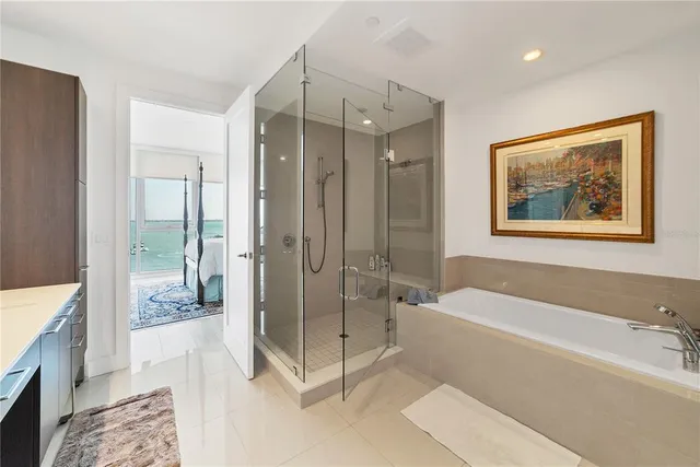 a spacious bathroom with a glass shower door and a sink