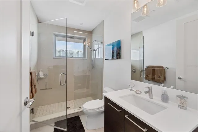 a bathroom with a sink toilet and shower