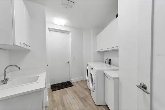 a kitchen with a sink a washer and dryer