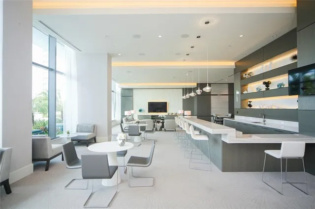 a living room with fireplace furniture and a large window