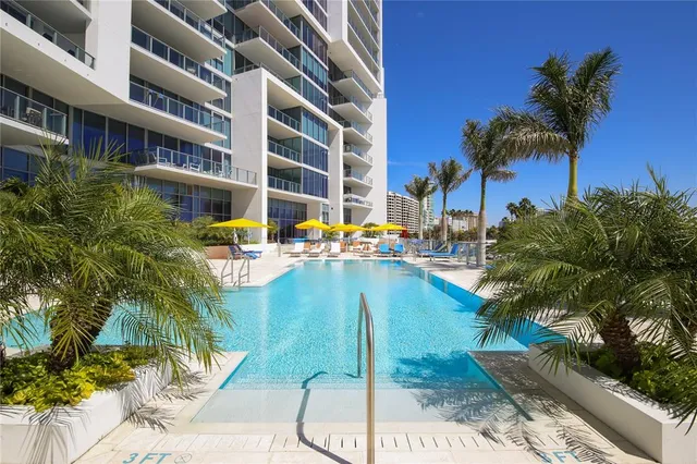 a swimming pool with outdoor seating and yard