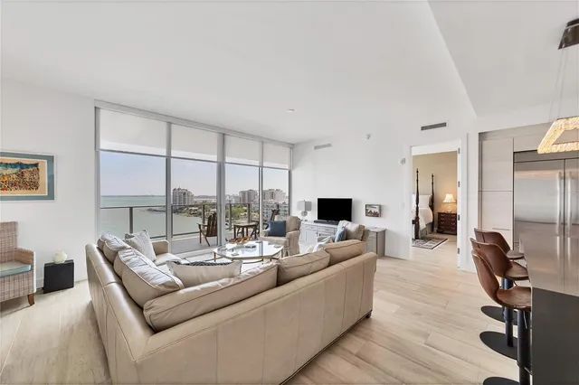 a living room with fireplace furniture and a large window