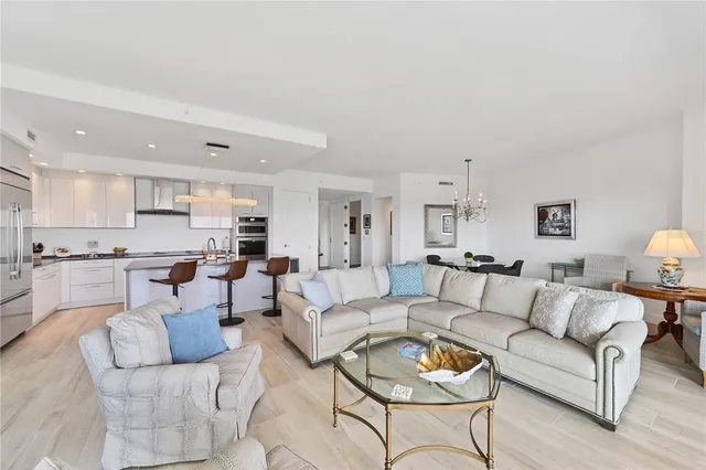 a living room with furniture kitchen view and a table