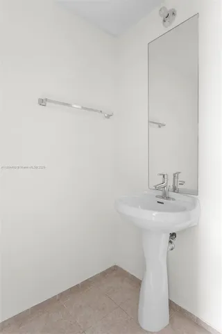 a white toilet sitting next to a bathroom sink