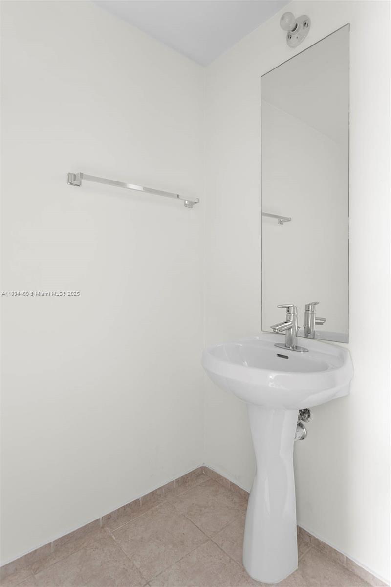 60 Southwest 13th Street, Unit 3213 Miami, FL 33130 - Photo 14 of 23 a bathroom with a sink