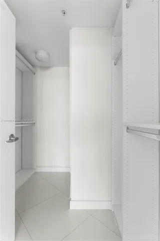 a view of washer and dryer with kitchen in the background