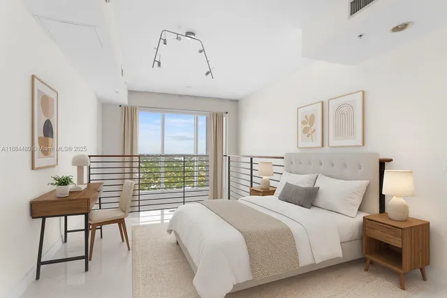 a bedroom with a bed and a view of kitchen