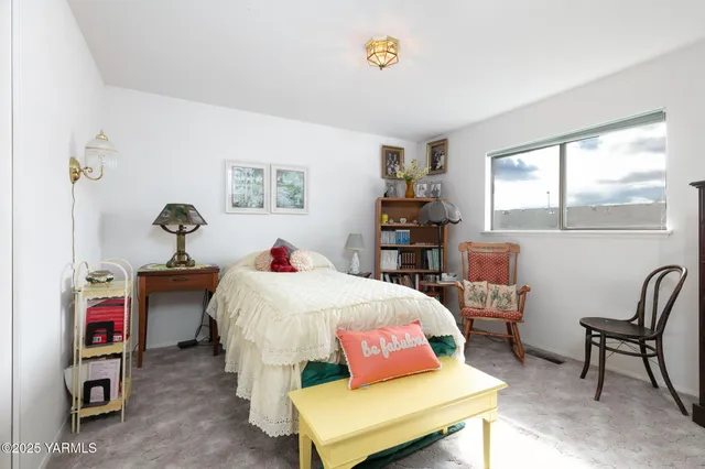 a bedroom with a bed and a table