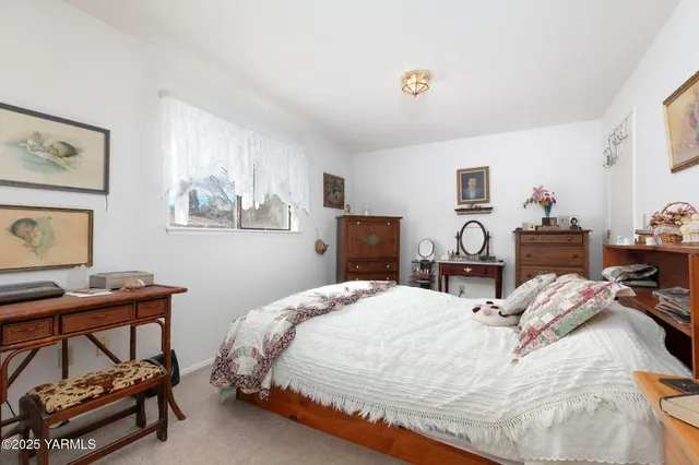 a bedroom with a bed a desk and chair