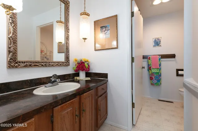a bathroom with a granite countertop sink a mirror and a shower