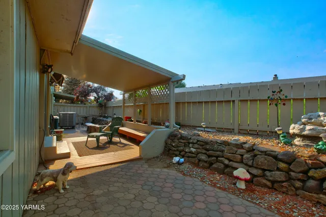 a view of a patio with table and chairs and potted plants