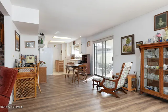 a living room with furniture a flat screen tv and a floor to ceiling window