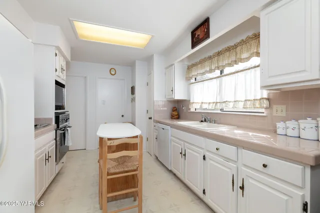 a spacious bathroom with a double vanity sink and a window