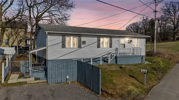 a view of a house with a patio and backyard
