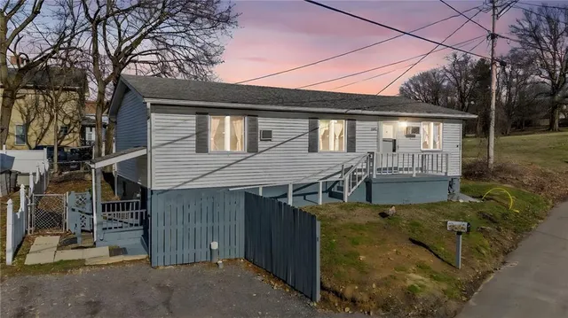 a view of a house with a patio and backyard