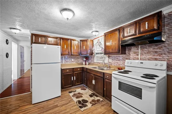 a kitchen with stainless steel appliances granite countertop a refrigerator stove microwave and sink
