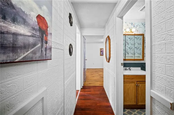 a view of a hallway with wooden floor and entryway