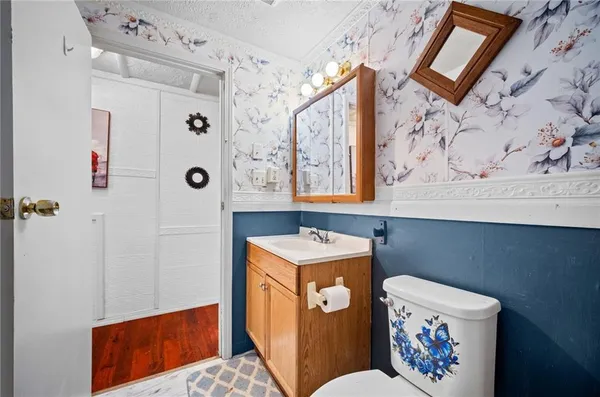 a utility room with a refrigerator and a sink