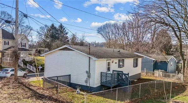 a view of house with backyard and trees