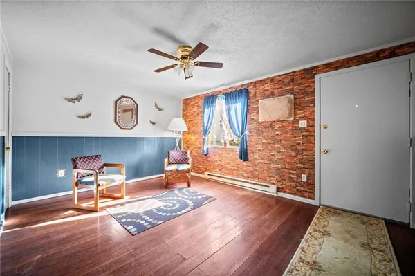 a living room with wooden floor and a window