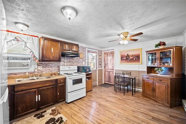 a kitchen with stainless steel appliances a stove a sink dishwasher and a refrigerator