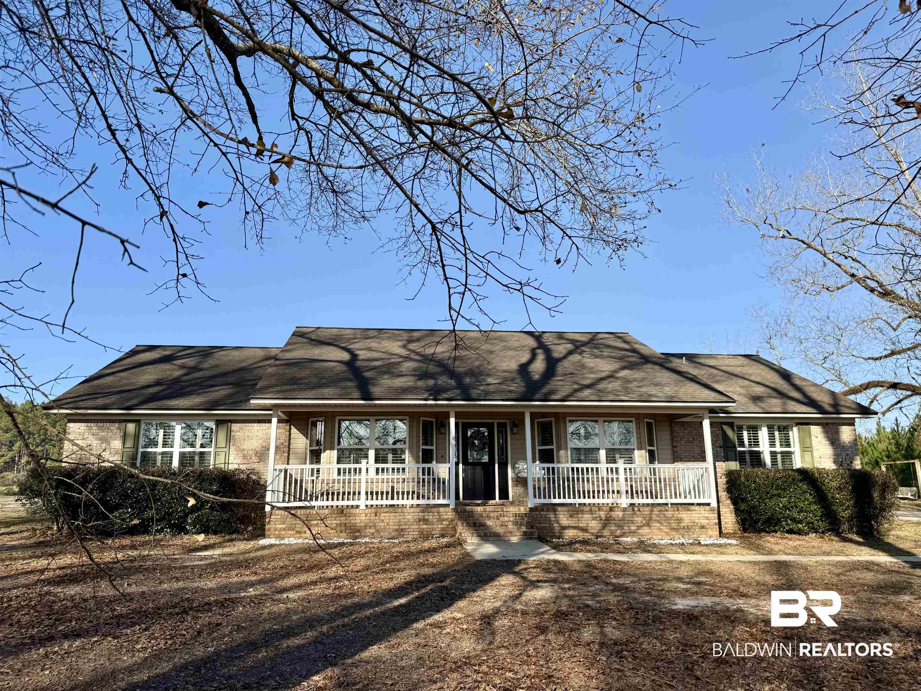 5646 Foshee Road Brewton, AL 36426 - Photo 36 of 37 Single story home featuring a porch, a shingled roof, and brick siding