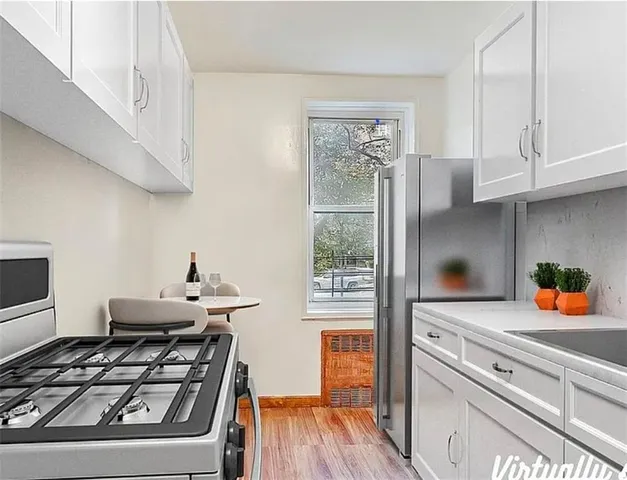 a kitchen with stainless steel appliances granite countertop a stove and a refrigerator