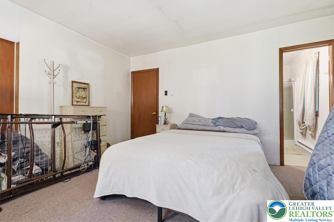 143 Logger Road Canadensis, PA 18325 - Photo 13 of 32 A cozy bedroom features carpeted flooring and white walls, offering a blank canvas for personalization.