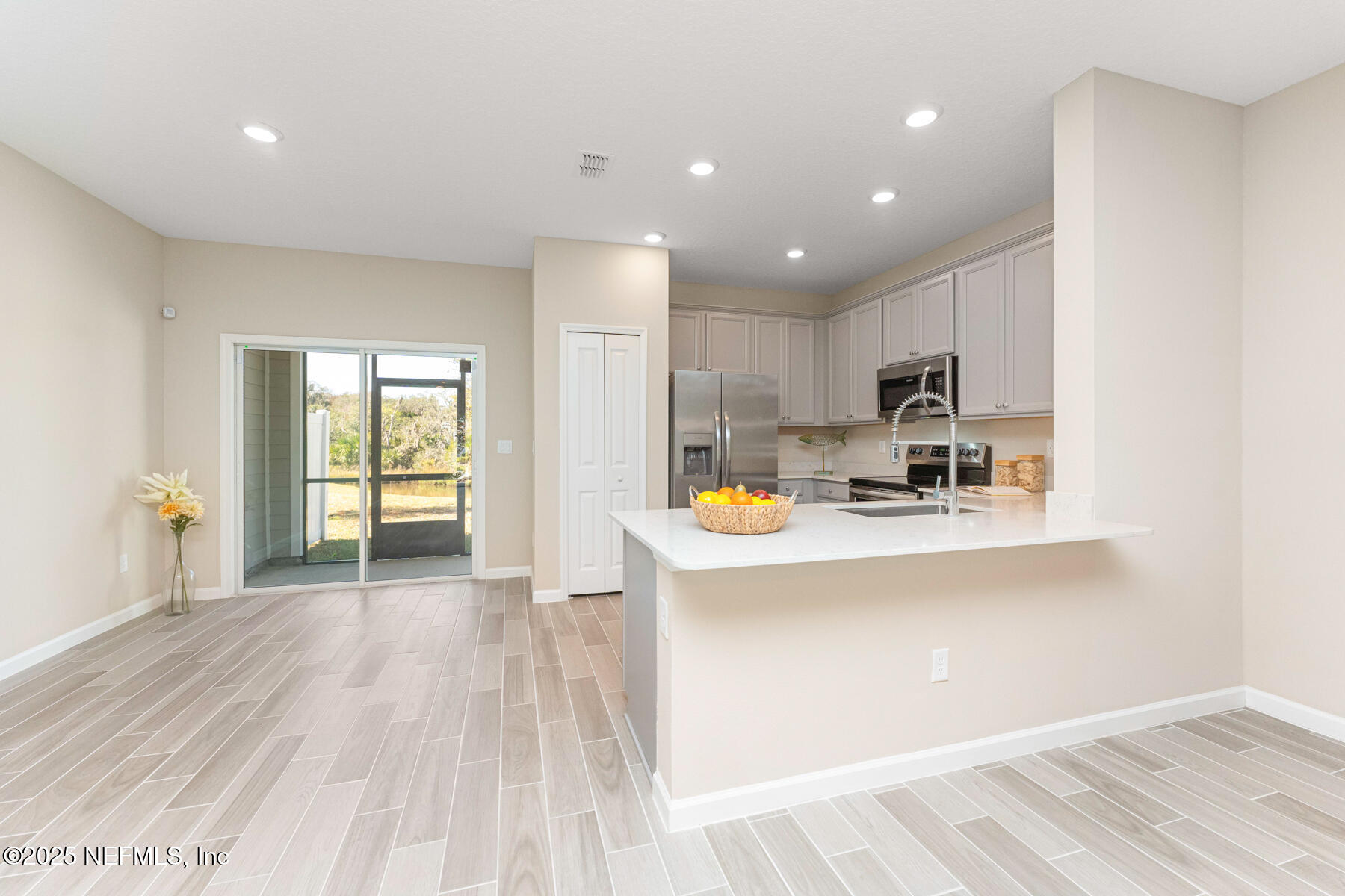 1171 Beach Dune Drive Jacksonville, FL 32233 - Photo 2 of 27 a view of kitchen with stainless steel appliances granite countertop a stove top oven a sink a counter space and cabinets