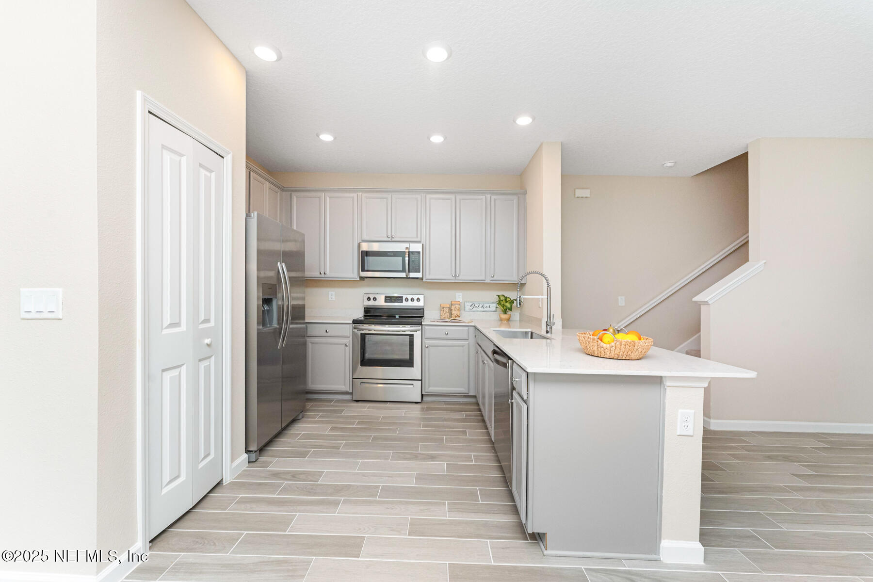 1171 Beach Dune Drive Jacksonville, FL 32233 - Photo 3 of 27 a kitchen that has a lot of white cabinets and stainless steel appliances