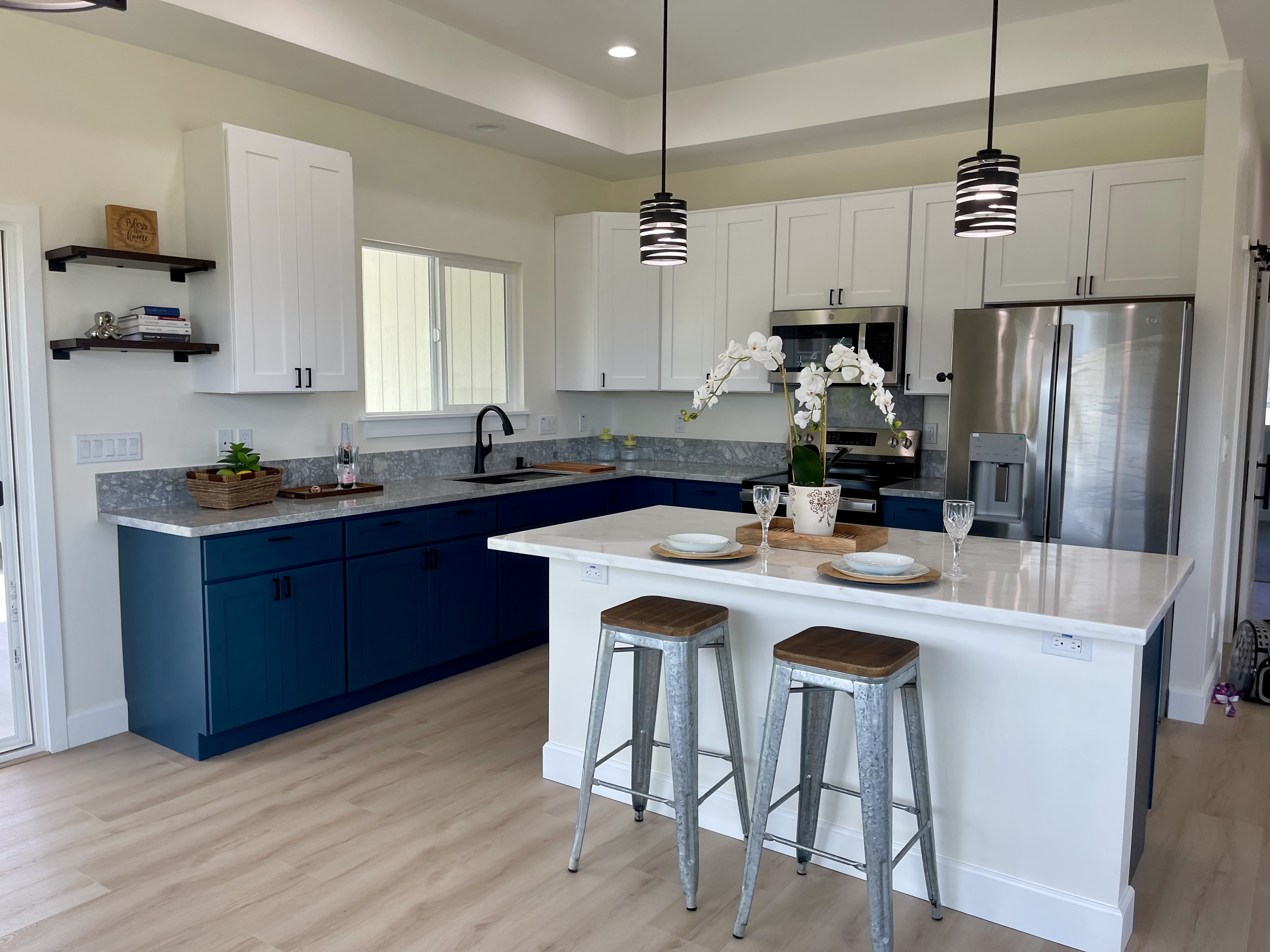 a kitchen with a sink a refrigerator a stove a dining table and chairs